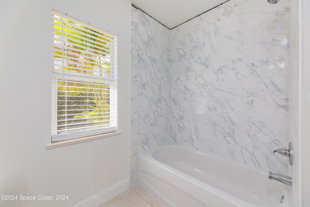 bathroom featuring tile patterned floors and tiled shower / bath combo