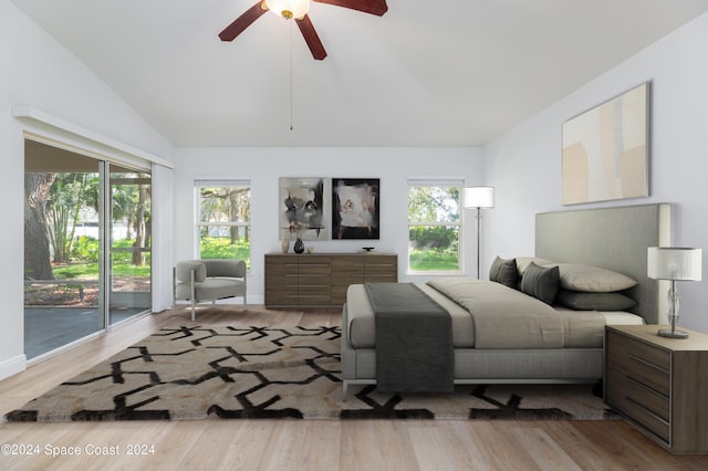 bedroom featuring access to outside, ceiling fan, light hardwood / wood-style flooring, and vaulted ceiling