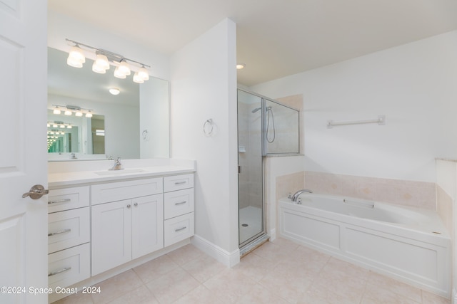 bathroom with tile patterned floors, vanity, and shower with separate bathtub