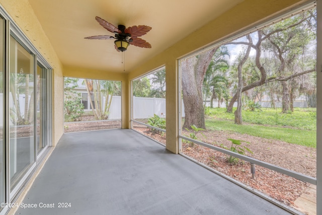 unfurnished sunroom with plenty of natural light and ceiling fan