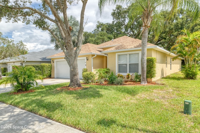 view of front of property with a front lawn and a garage