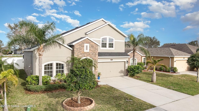 view of front of home with a front lawn and a garage