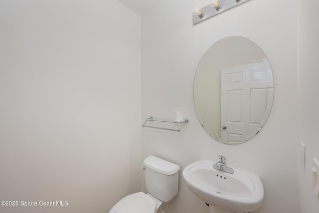 bathroom with toilet and sink