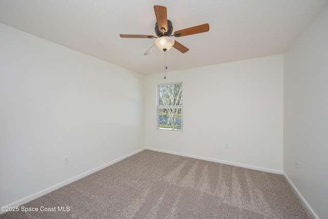 unfurnished room with ceiling fan and carpet flooring