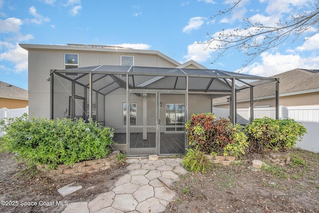 rear view of property with glass enclosure