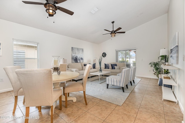 tiled dining area featuring ceiling fan and vaulted ceiling