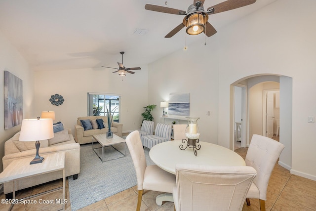 tiled dining area with high vaulted ceiling