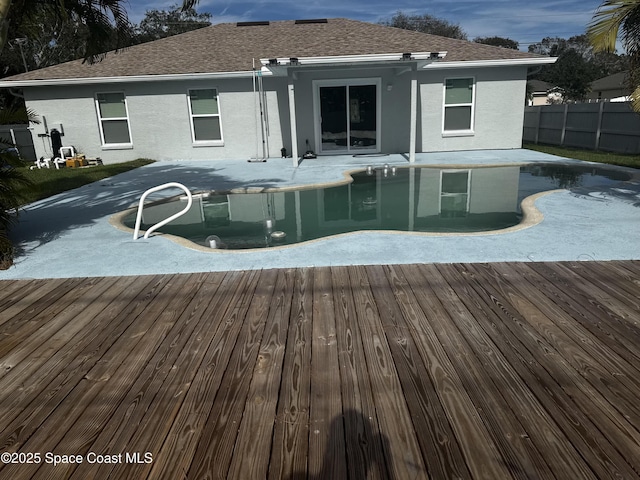 view of swimming pool with a deck