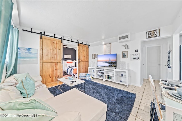 tiled living room featuring a barn door