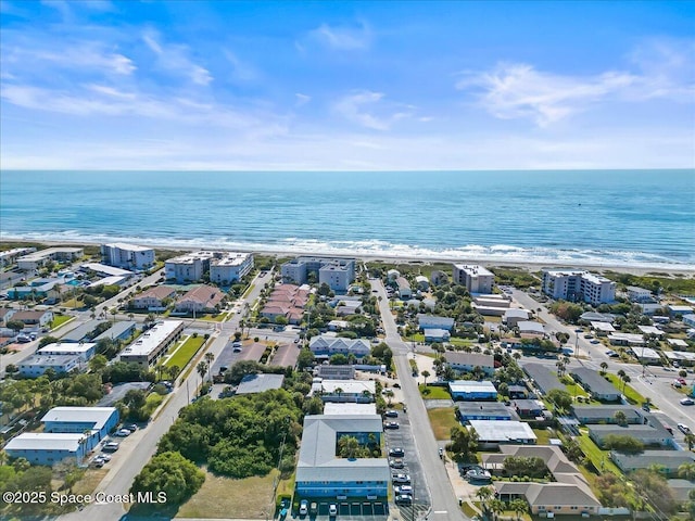 drone / aerial view featuring a water view and a view of the beach