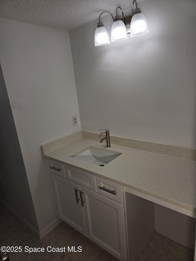 bathroom featuring a textured ceiling, vanity, and tile patterned floors