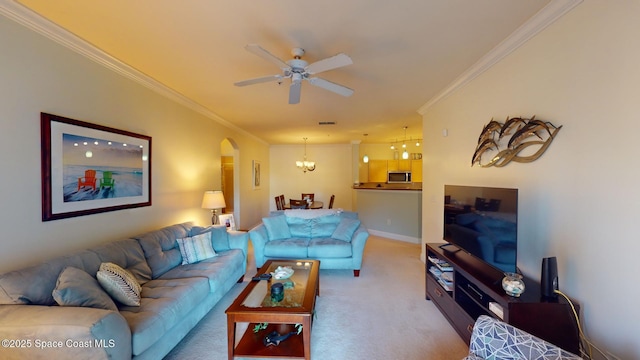 living room featuring carpet flooring, ceiling fan with notable chandelier, and ornamental molding