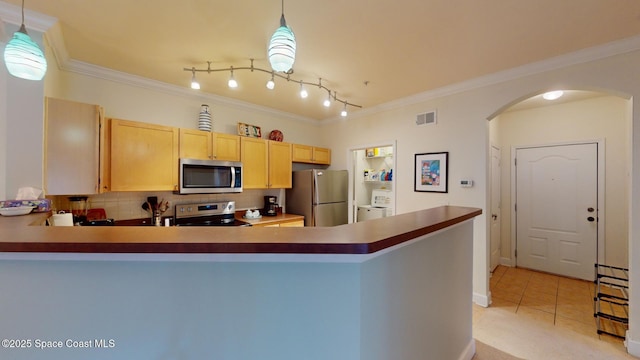 kitchen featuring kitchen peninsula, light brown cabinetry, stainless steel appliances, pendant lighting, and light tile patterned floors