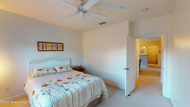 bedroom with ceiling fan and light colored carpet