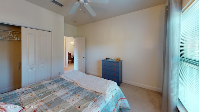 bedroom with light carpet, a closet, and ceiling fan