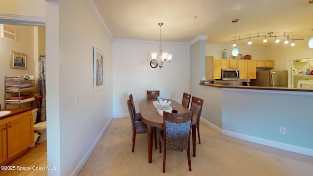 dining space featuring ornamental molding, light carpet, and a chandelier