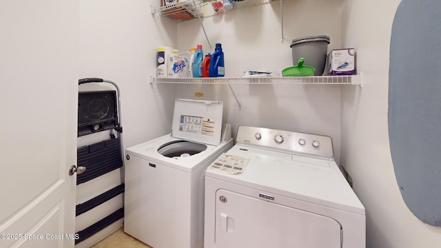 clothes washing area featuring washing machine and clothes dryer