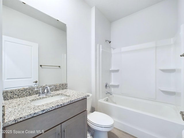 full bathroom with shower / washtub combination, vanity, and toilet