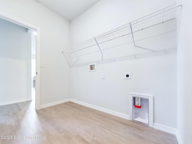 washroom featuring hookup for an electric dryer, hookup for a washing machine, and light hardwood / wood-style flooring