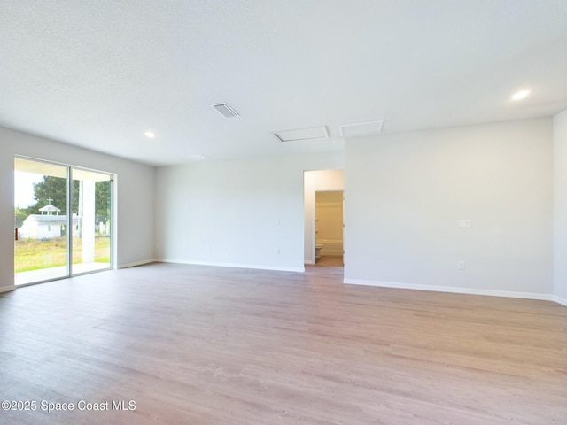 spare room with light wood-type flooring