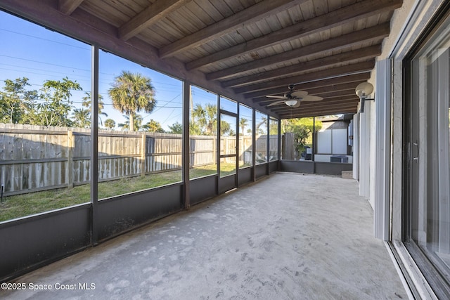 unfurnished sunroom featuring beam ceiling