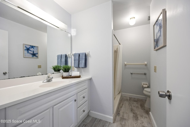 bathroom with toilet, walk in shower, hardwood / wood-style flooring, and vanity