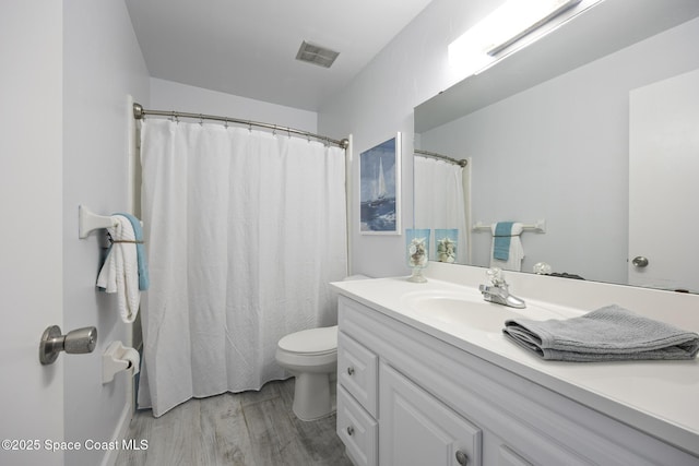 bathroom featuring hardwood / wood-style floors, toilet, and vanity