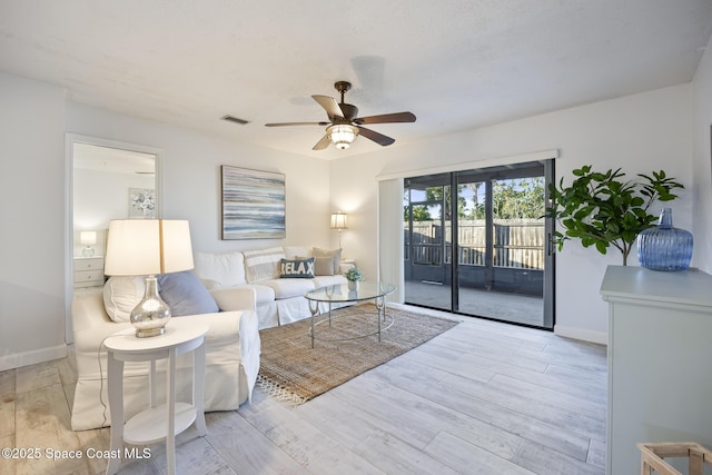 living room with light wood-type flooring and ceiling fan