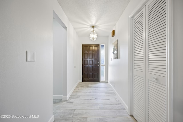 interior space featuring a textured ceiling and light wood-type flooring