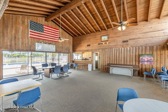 miscellaneous room with ceiling fan, beam ceiling, carpet flooring, high vaulted ceiling, and wooden ceiling