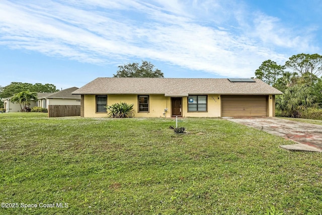 ranch-style home featuring solar panels, a front lawn, and a garage