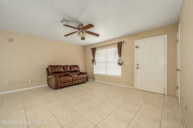 tiled living room featuring ceiling fan