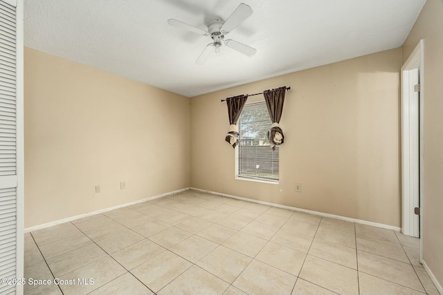 spare room featuring light tile patterned floors and ceiling fan