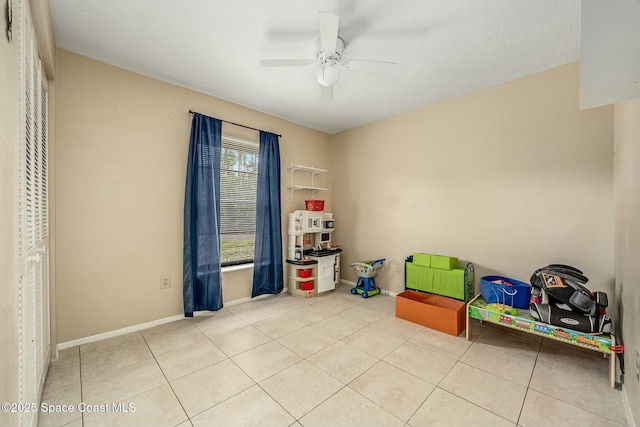 recreation room featuring ceiling fan and light tile patterned flooring