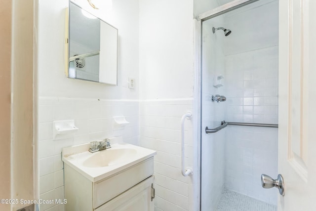 bathroom featuring vanity, tile walls, and tiled shower