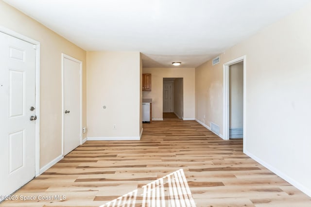 empty room with light hardwood / wood-style flooring