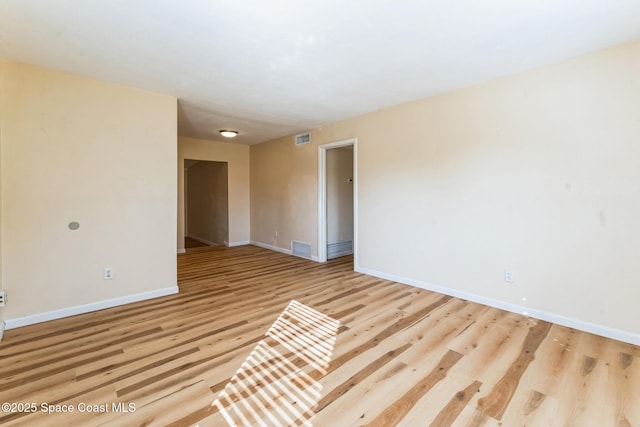 unfurnished room with light wood-type flooring