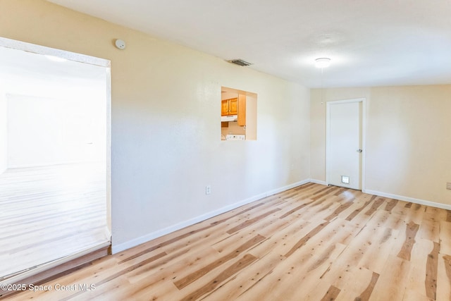 spare room featuring light hardwood / wood-style floors