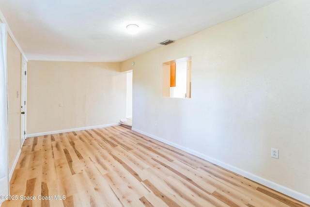 spare room with light hardwood / wood-style flooring