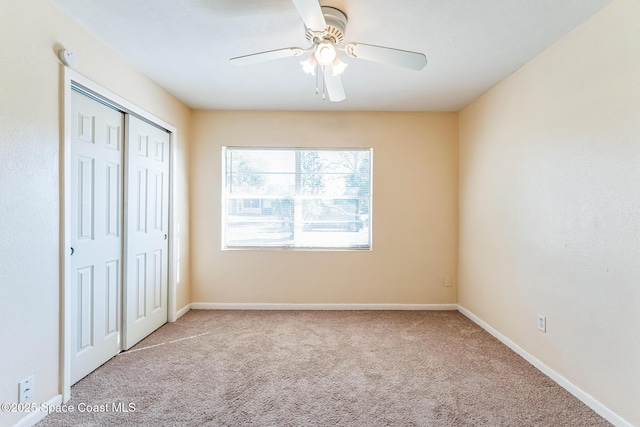 unfurnished bedroom with light carpet, a closet, and ceiling fan