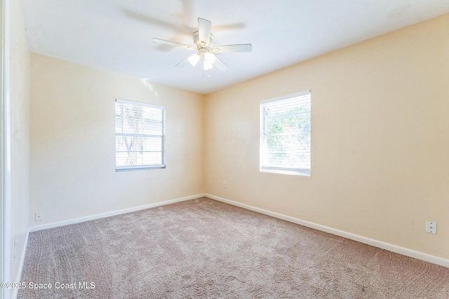 carpeted empty room featuring ceiling fan