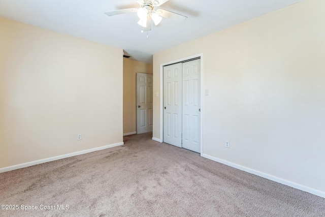 unfurnished bedroom with ceiling fan, light colored carpet, and a closet