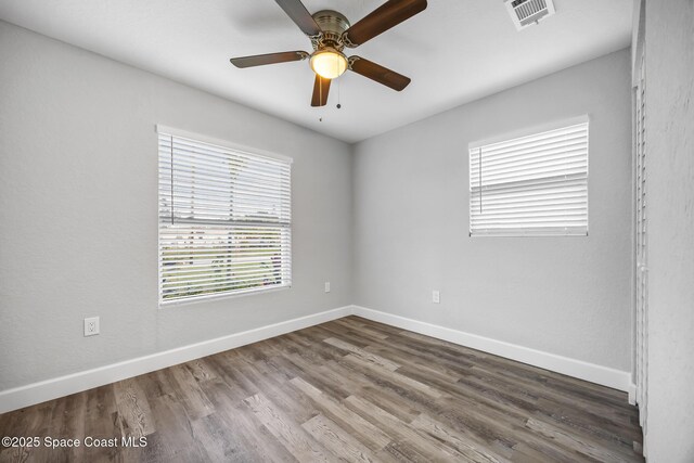 empty room with hardwood / wood-style flooring and ceiling fan