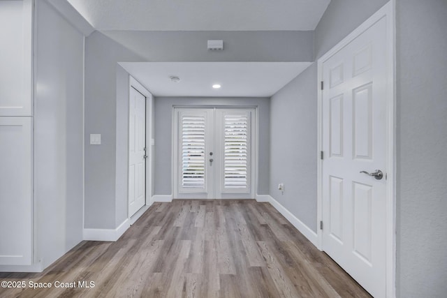 entrance foyer featuring light hardwood / wood-style floors and french doors