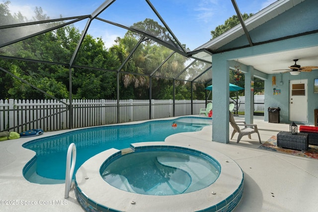 view of swimming pool with a patio area, an in ground hot tub, ceiling fan, and glass enclosure