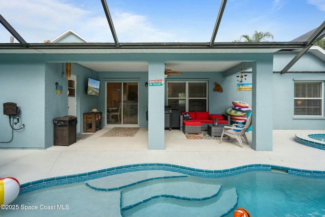 view of swimming pool featuring a patio area, an outdoor living space, ceiling fan, and glass enclosure