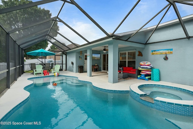 view of pool with an in ground hot tub, an outdoor hangout area, ceiling fan, glass enclosure, and a patio area