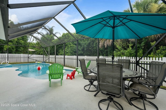 view of swimming pool with glass enclosure and a patio