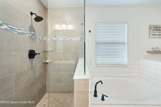 bathroom featuring shower with separate bathtub