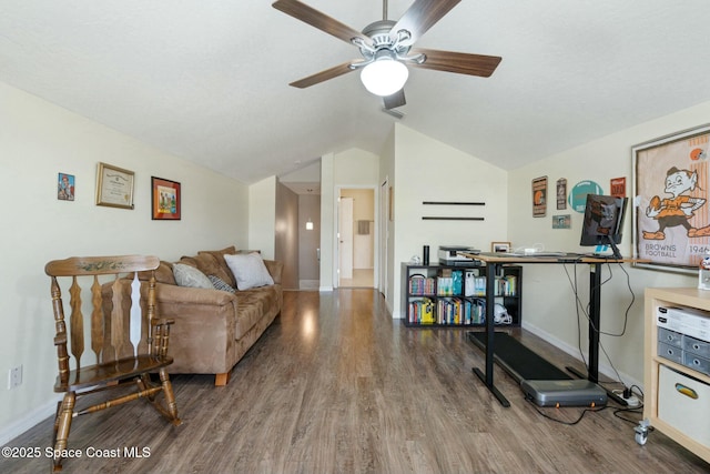 living room featuring hardwood / wood-style floors, vaulted ceiling, and ceiling fan